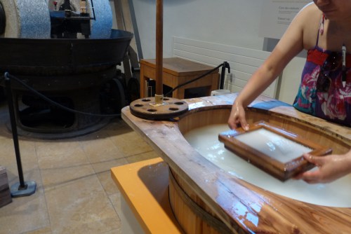 My new friend sifts paper pulp in the hands-on part of the museum